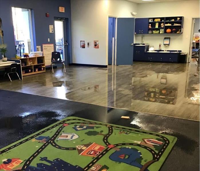 Daycare room with standing water on laminate floor