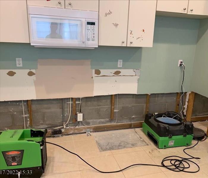 Removed kitchen drywall and baseboards with SERVPRO LGR dehumidifier an air scrubber