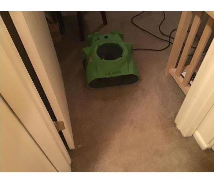 One of our air movers drying the carpet in this home