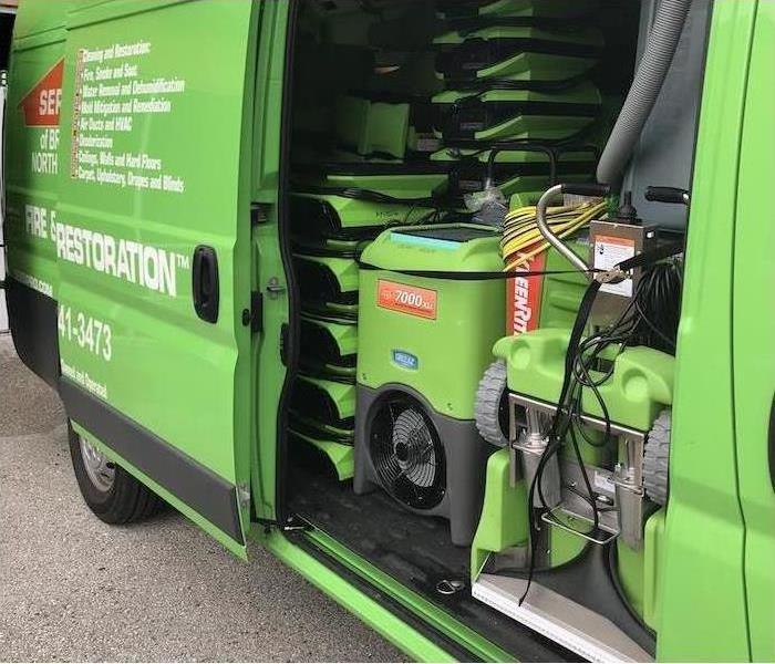 One of our green fleet vans with the door open showing all our restoration equipment inside