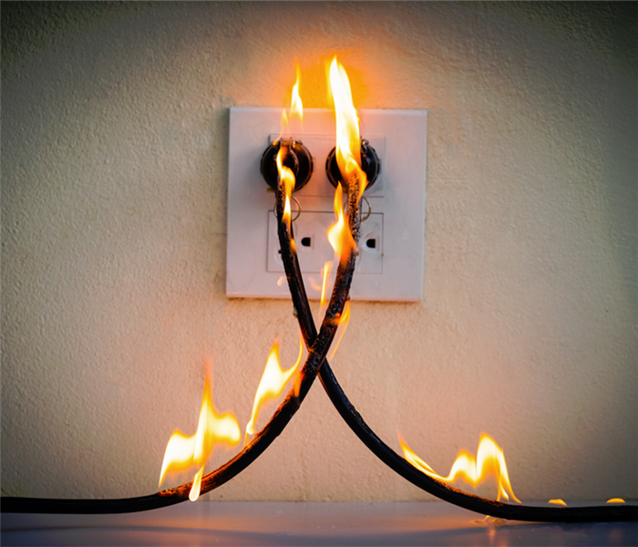 an outlet with wires on fire