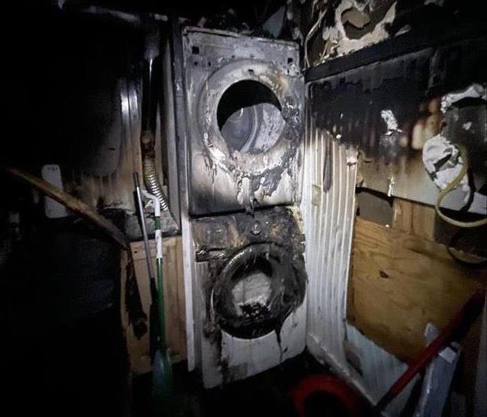 Badly burned out utility room with completely burned appliances