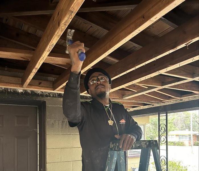 SERVPRO team member inspecting rafters for signs of damage
